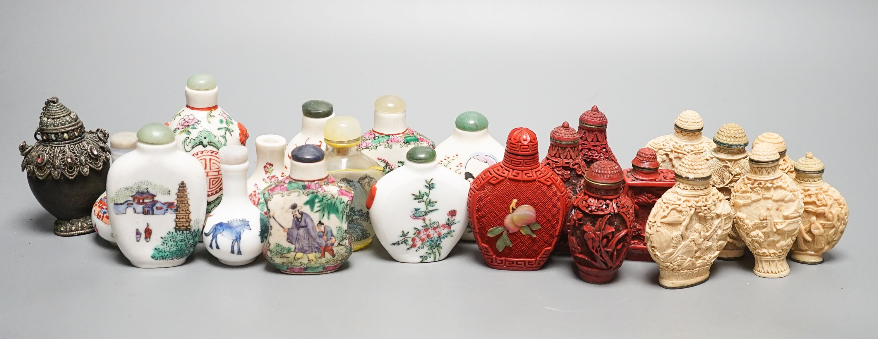 A collection of Chinese snuff bottles, 20th century, including a carved cinnabar lacquer and hardstone inlaid snuff bottle, 7.4cm (23)